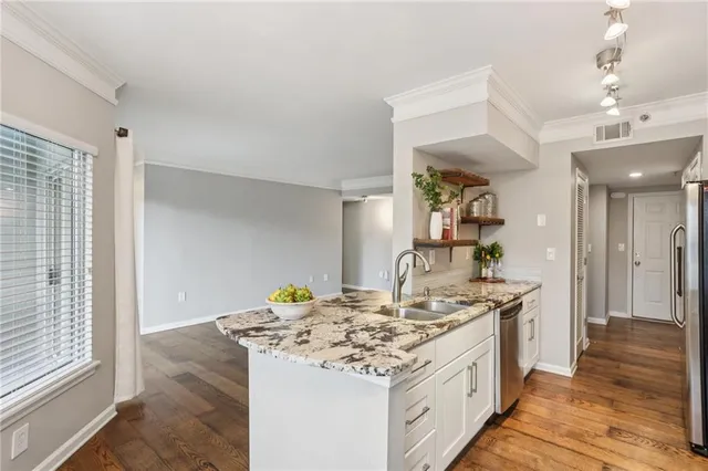 a kitchen with a sink stove and cabinets