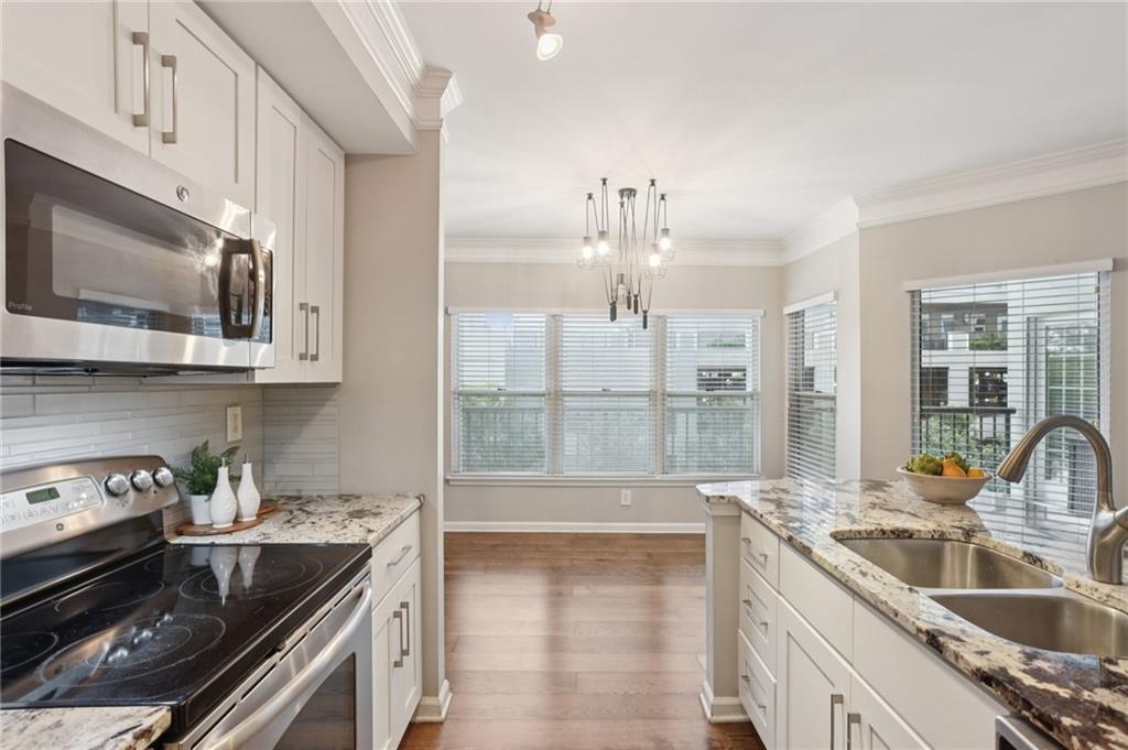 275 13th Street Northeast, Unit 312 Atlanta, GA 30309 - Photo 4 of 31 a kitchen with a sink and a stove top oven