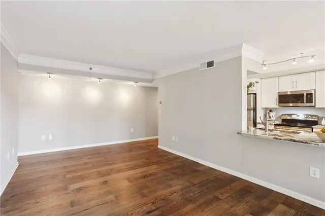 a view of a kitchen with wooden floor and a sink