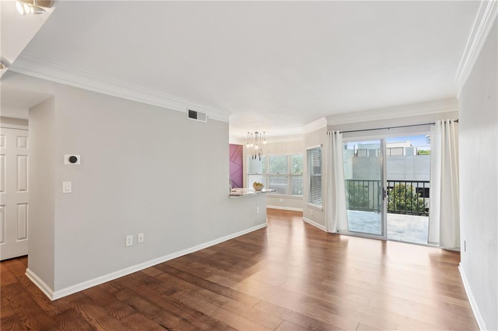 275 13th Street Northeast, Unit 312 Atlanta, GA 30309 - Photo 8 of 31 wooden floor in an empty room with a window
