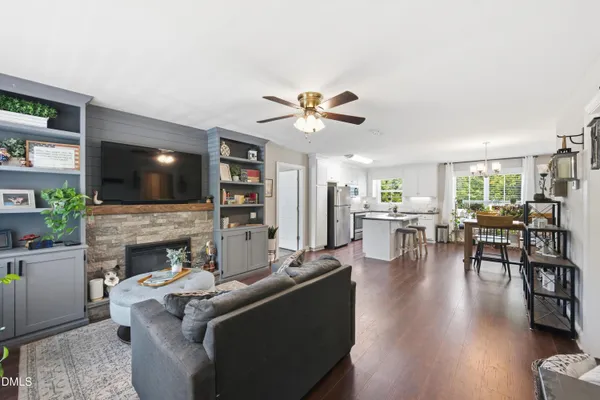 a living room with furniture fireplace and flat screen tv