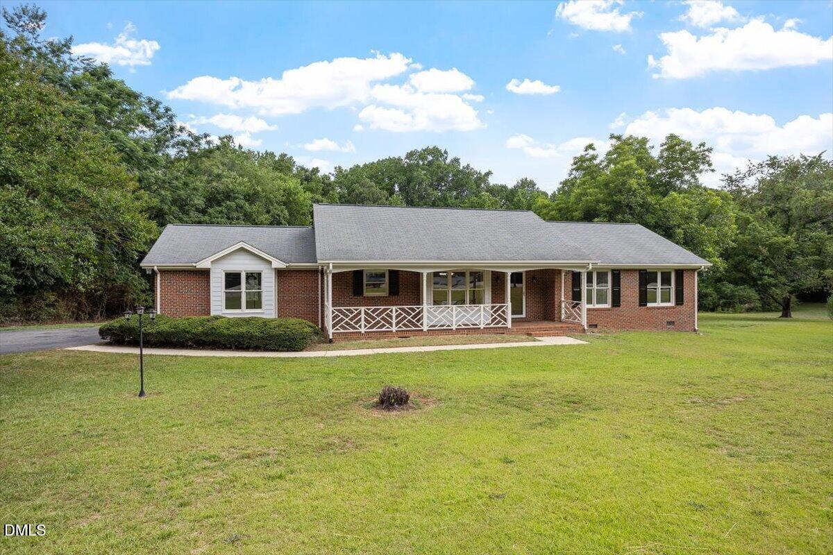805 Rand Road Garner, NC 27529 - Photo 5 of 38 a front view of a house with a garden