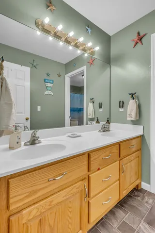 a bathroom with a double vanity sink and a mirror