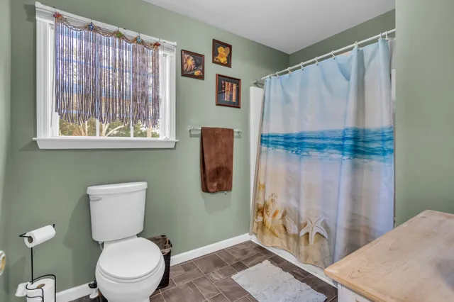 a bathroom with a toilet a sink and a shower