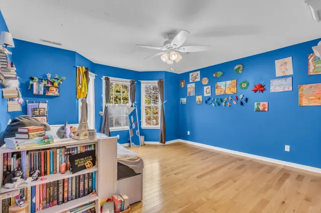 a bed room with a bed and a bookshelf