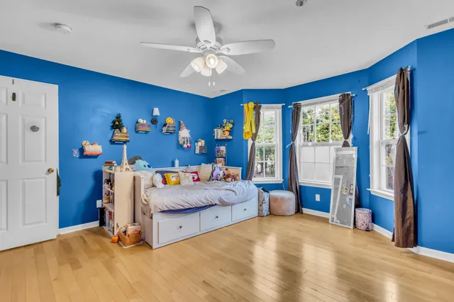 a bed room with a bed and a ceiling fan