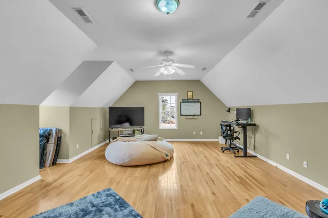 a bedroom with furniture and a wooden floor