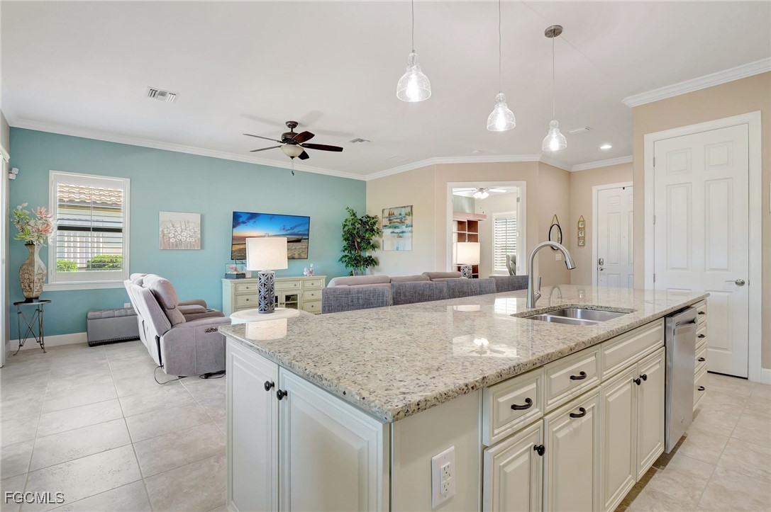 11716 Avingston Terrace Fort Myers, FL 33913 - Photo 11 of 49 a hall with kitchen island a sink granite counter tops and a view of living room