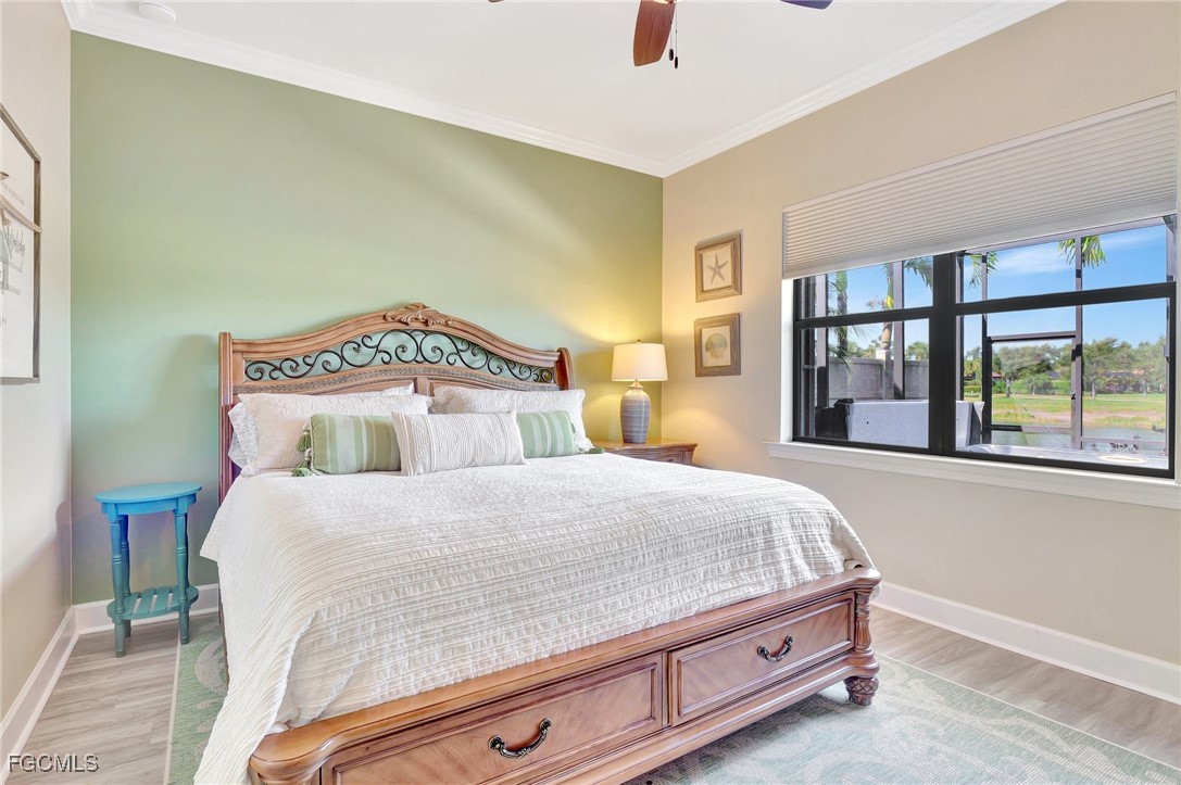 11716 Avingston Terrace Fort Myers, FL 33913 - Photo 19 of 49 a bedroom with a bed and a large window