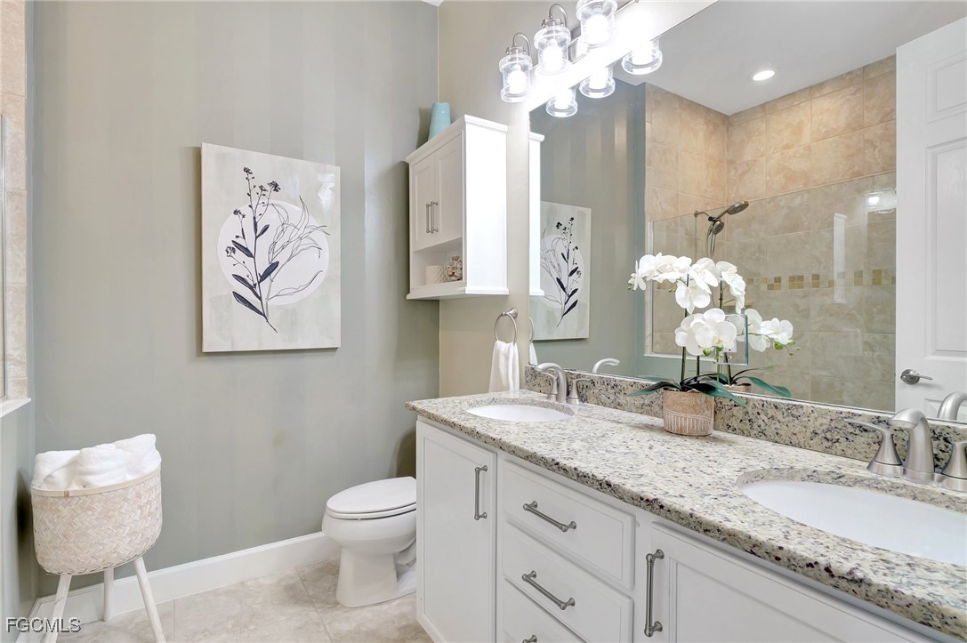 11716 Avingston Terrace Fort Myers, FL 33913 - Photo 21 of 49 a bathroom with a granite countertop toilet sink and mirror