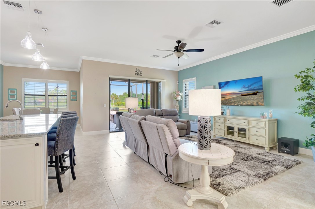 11716 Avingston Terrace Fort Myers, FL 33913 - Photo 3 of 49 a living room with furniture a dining table and a fireplace