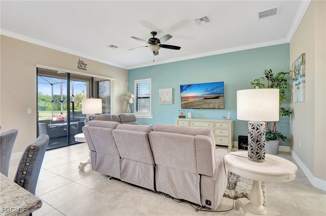 11716 Avingston Terrace Fort Myers, FL 33913 - Photo 4 of 49 a living room with furniture a large window and a flat screen tv
