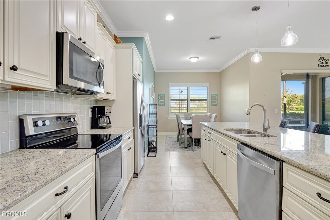 11716 Avingston Terrace Fort Myers, FL 33913 - Photo 9 of 49 a kitchen with stainless steel appliances granite countertop a sink stove and refrigerator