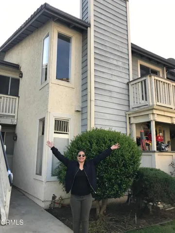 a front view of a house with plants