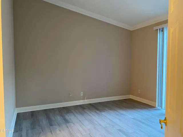 a view of an empty room and wooden floor