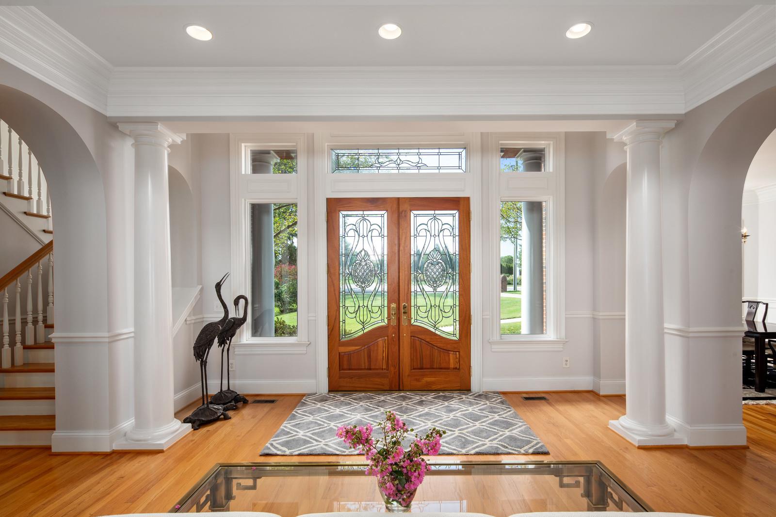 Entry foyer has stunning windows, double front doors and a decorative transom window. The first thing you see as you enter is the lake!