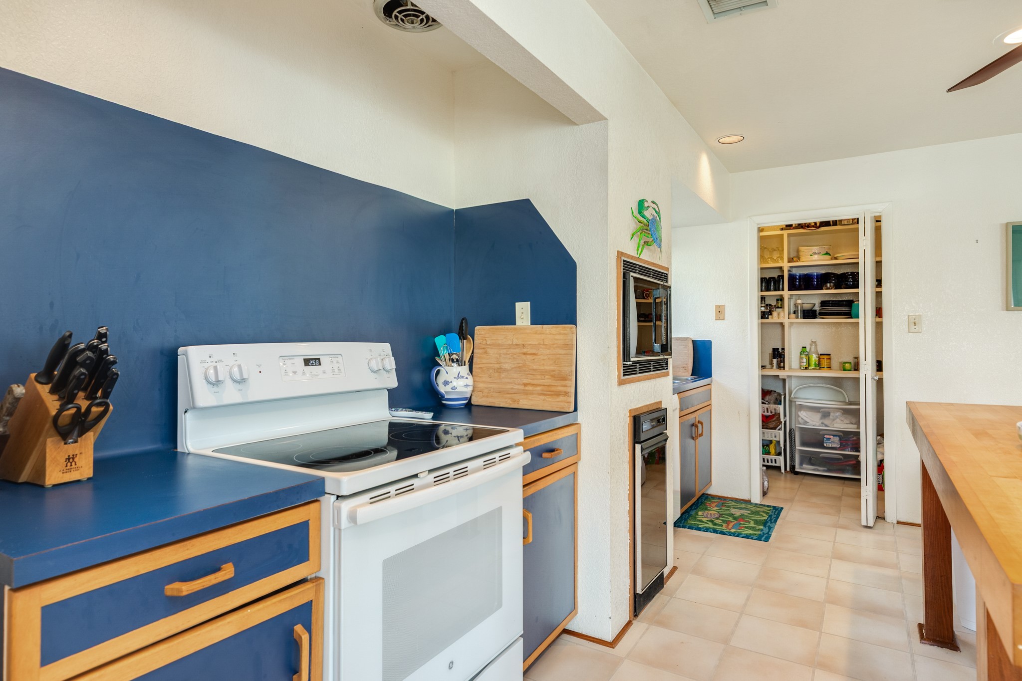 16708 Cormorant Road Jamaica Beach, TX 77554 - Photo 19 of 33 Kitchen view with pantry/utility room in view.