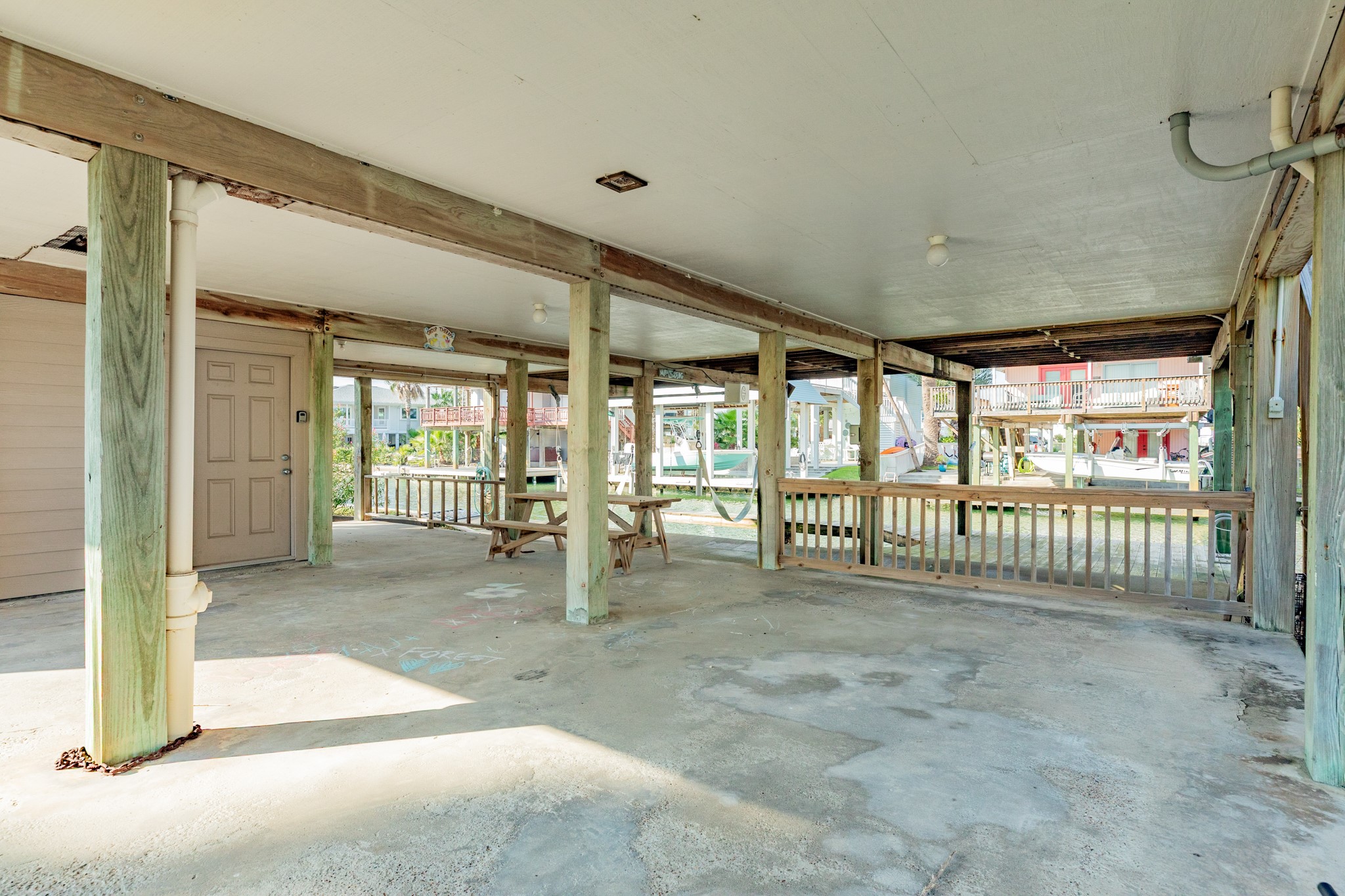 16708 Cormorant Road Jamaica Beach, TX 77554 - Photo 26 of 33 Nice large area under home for parking or outdoor entertaining. Door in view leads to a storage room.