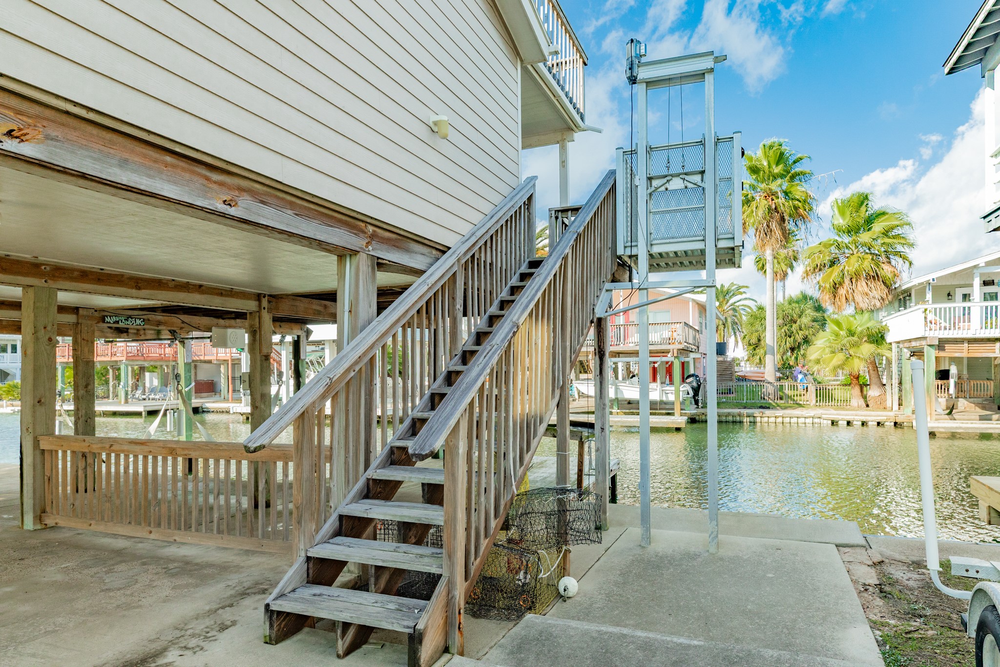 16708 Cormorant Road Jamaica Beach, TX 77554 - Photo 6 of 33 Staircase leading up to main deck/front entrance. Cargo lift in need of servicing.