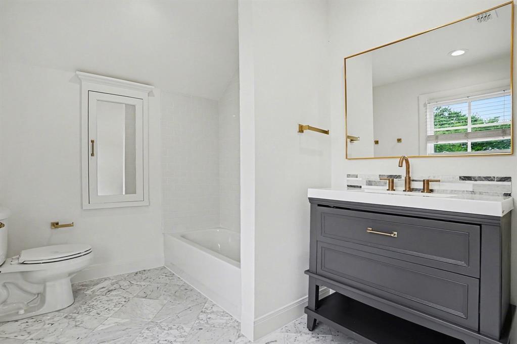 3923 Ranch Estates Circle Plano, TX 75074 - Photo 22 of 32 a bathroom with a sink a toilet and shower