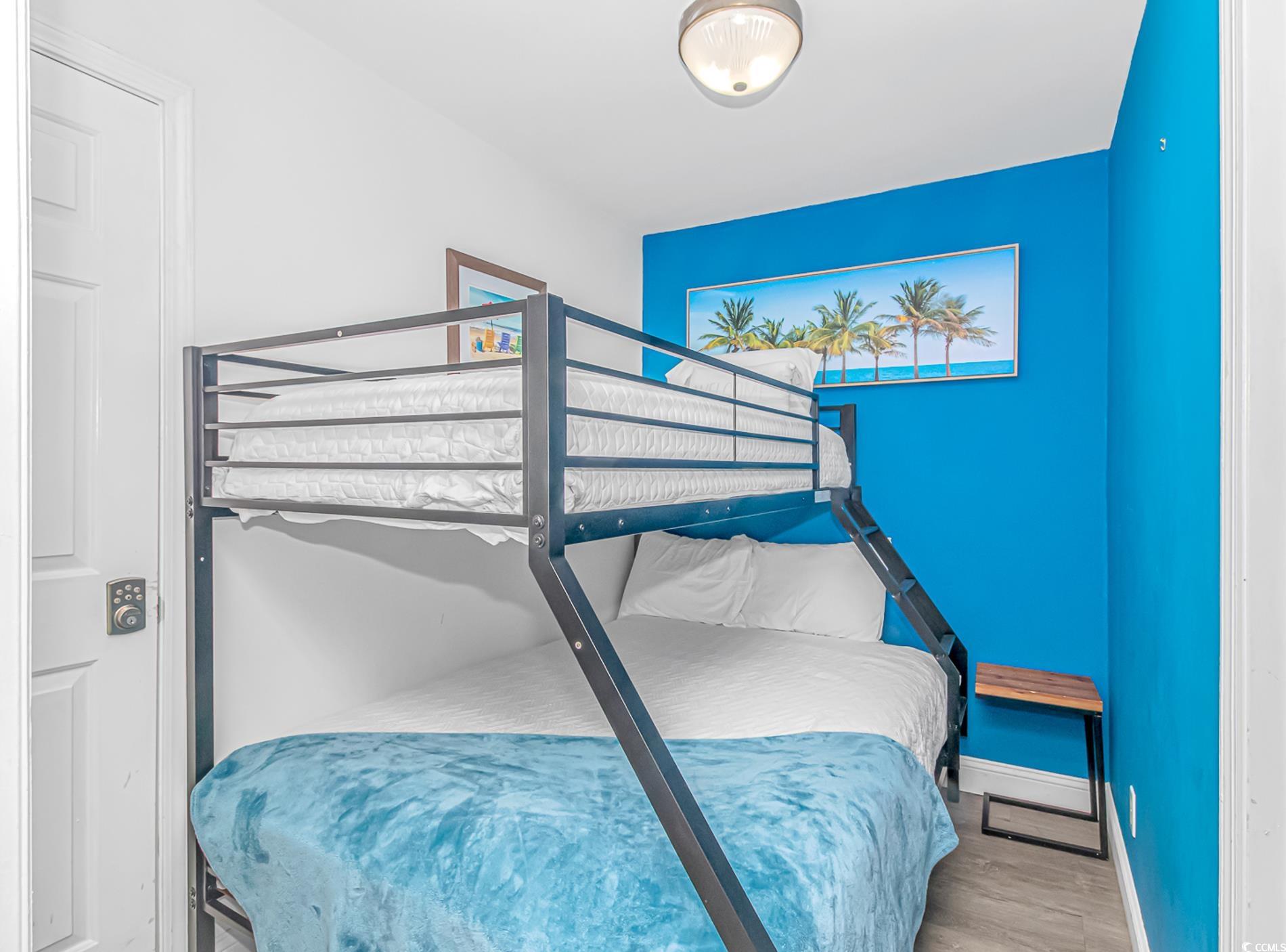 301 North Waccamaw Drive, Unit 211 Murrells Inlet, SC 29576 - Photo 11 of 37 Bedroom featuring wood finished floors and baseboards