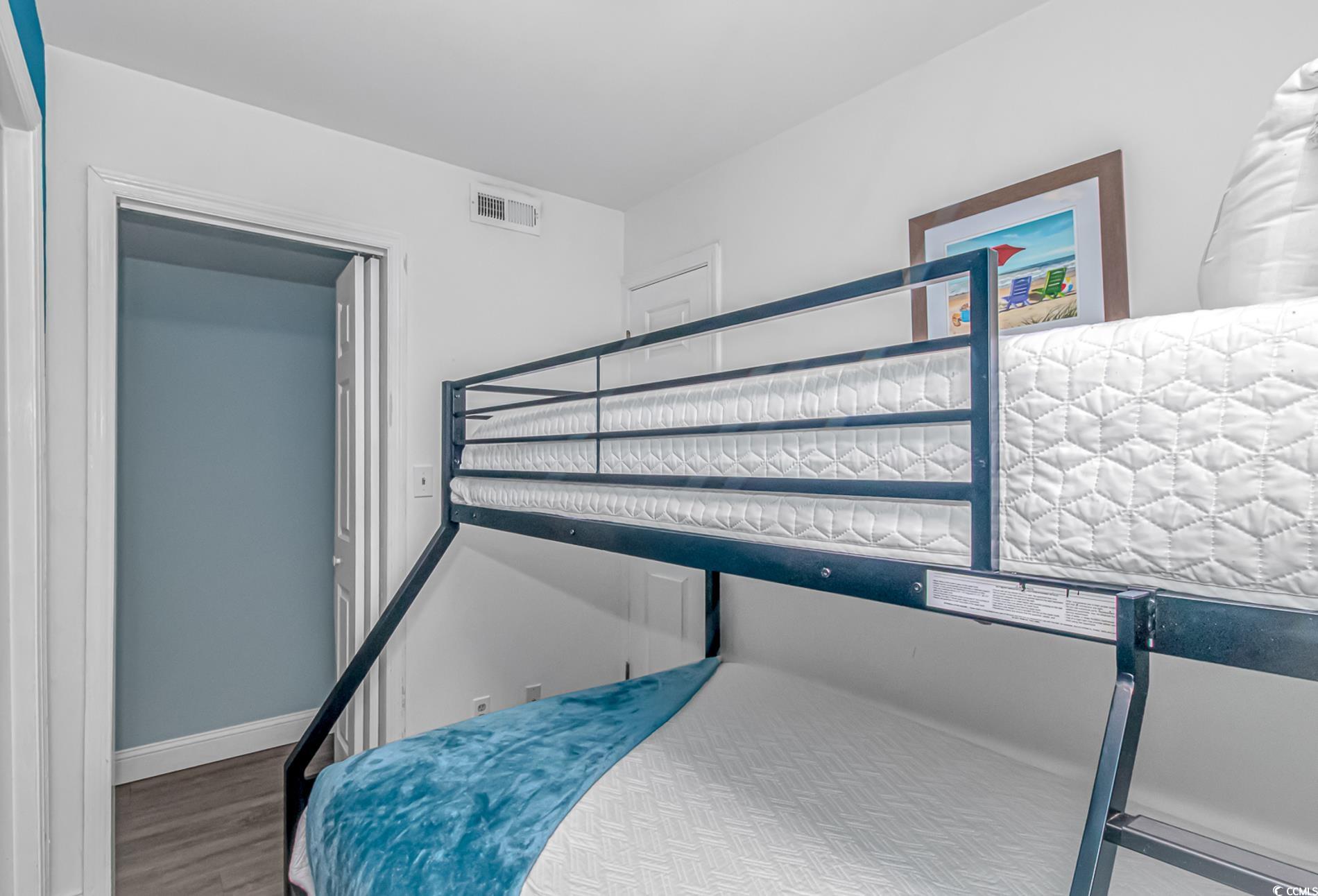 301 North Waccamaw Drive, Unit 211 Murrells Inlet, SC 29576 - Photo 12 of 37 Bedroom with wood finished floors and baseboards