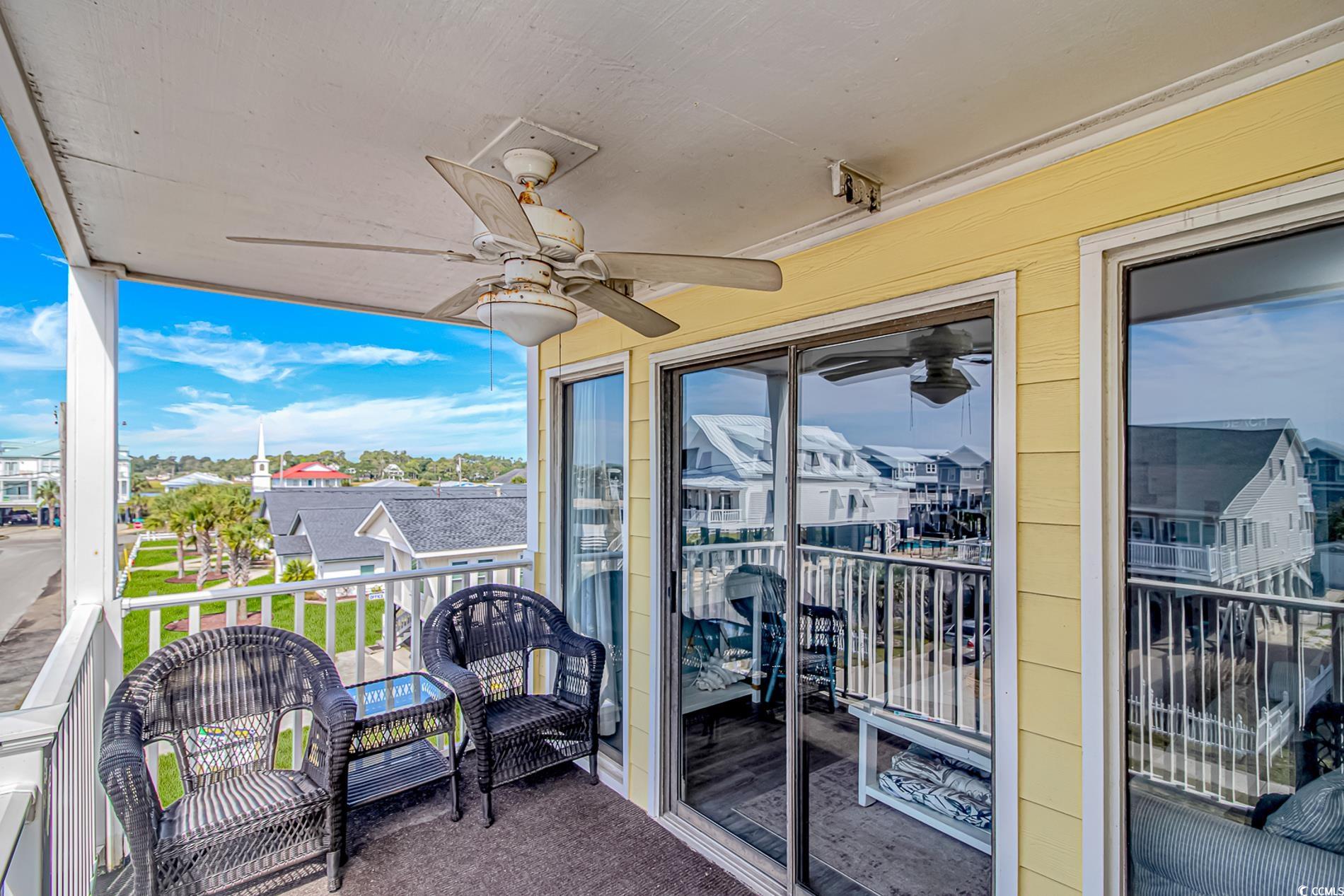 301 North Waccamaw Drive, Unit 211 Murrells Inlet, SC 29576 - Photo 14 of 37 Balcony with a ceiling fan and a residential view