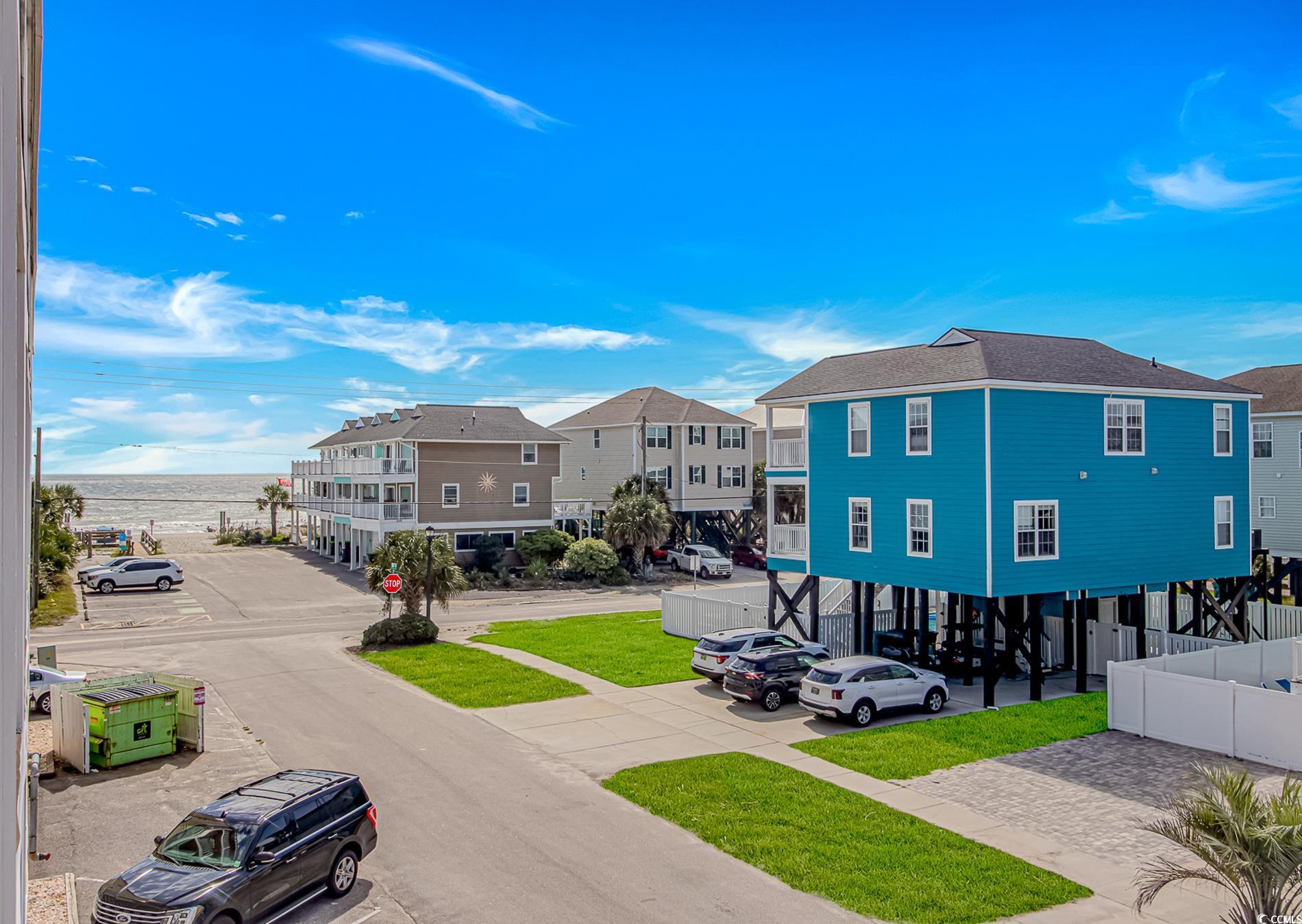 301 North Waccamaw Drive, Unit 211 Murrells Inlet, SC 29576 - Photo 16 of 37 View of asphalt road with a water view, sidewalks, traffic signs, and a residential view