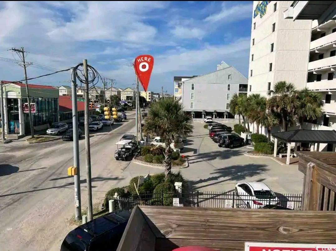 301 North Waccamaw Drive, Unit 211 Murrells Inlet, SC 29576 - Photo 18 of 37 View of asphalt street with curbs, sidewalks, and traffic signs