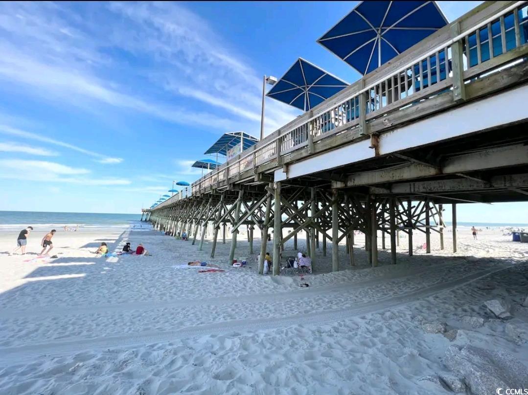 301 North Waccamaw Drive, Unit 211 Murrells Inlet, SC 29576 - Photo 23 of 37 Surrounding community featuring a pier and view of water and beach