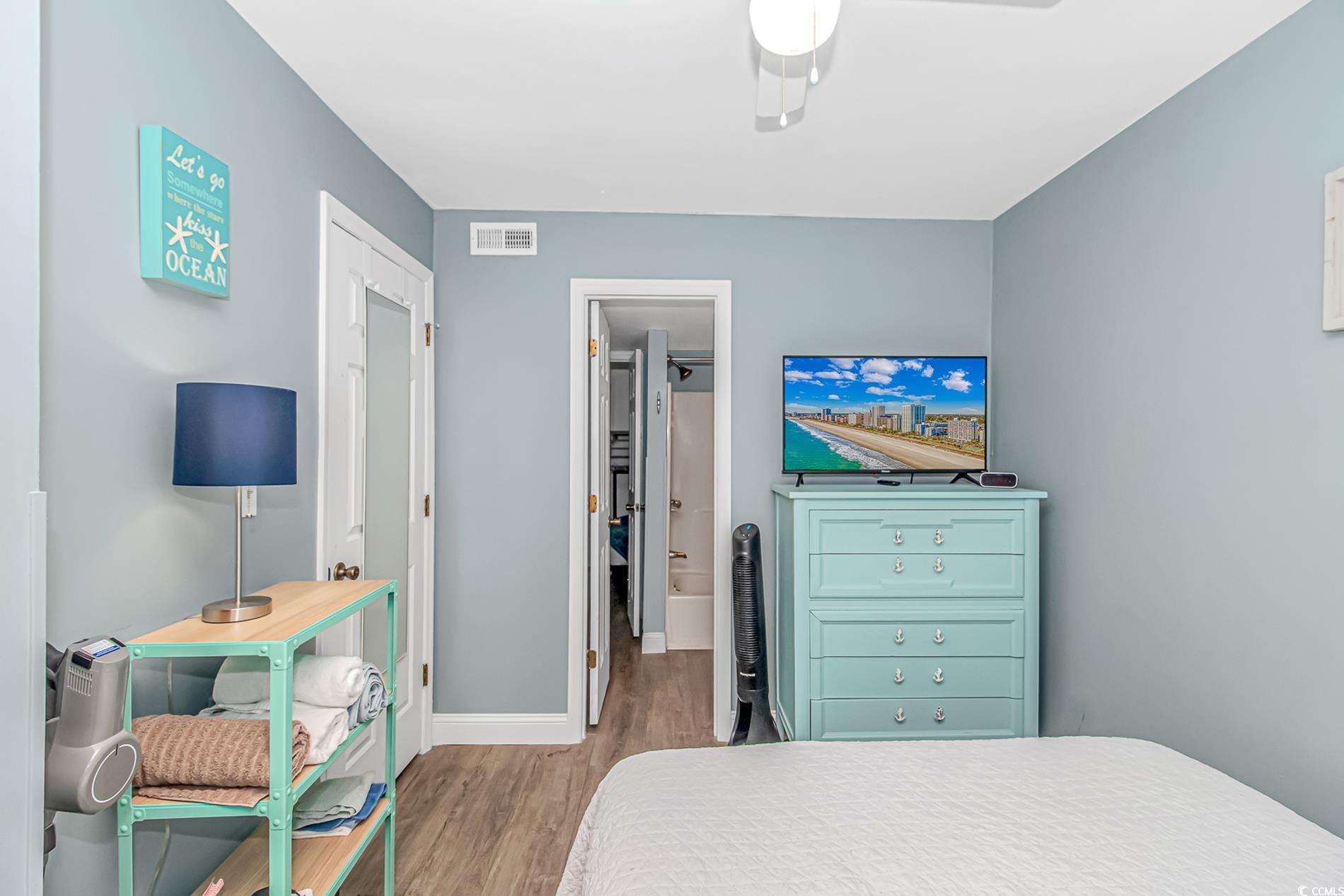 301 North Waccamaw Drive, Unit 211 Murrells Inlet, SC 29576 - Photo 8 of 37 Bedroom featuring light wood-style floors and a ceiling fan