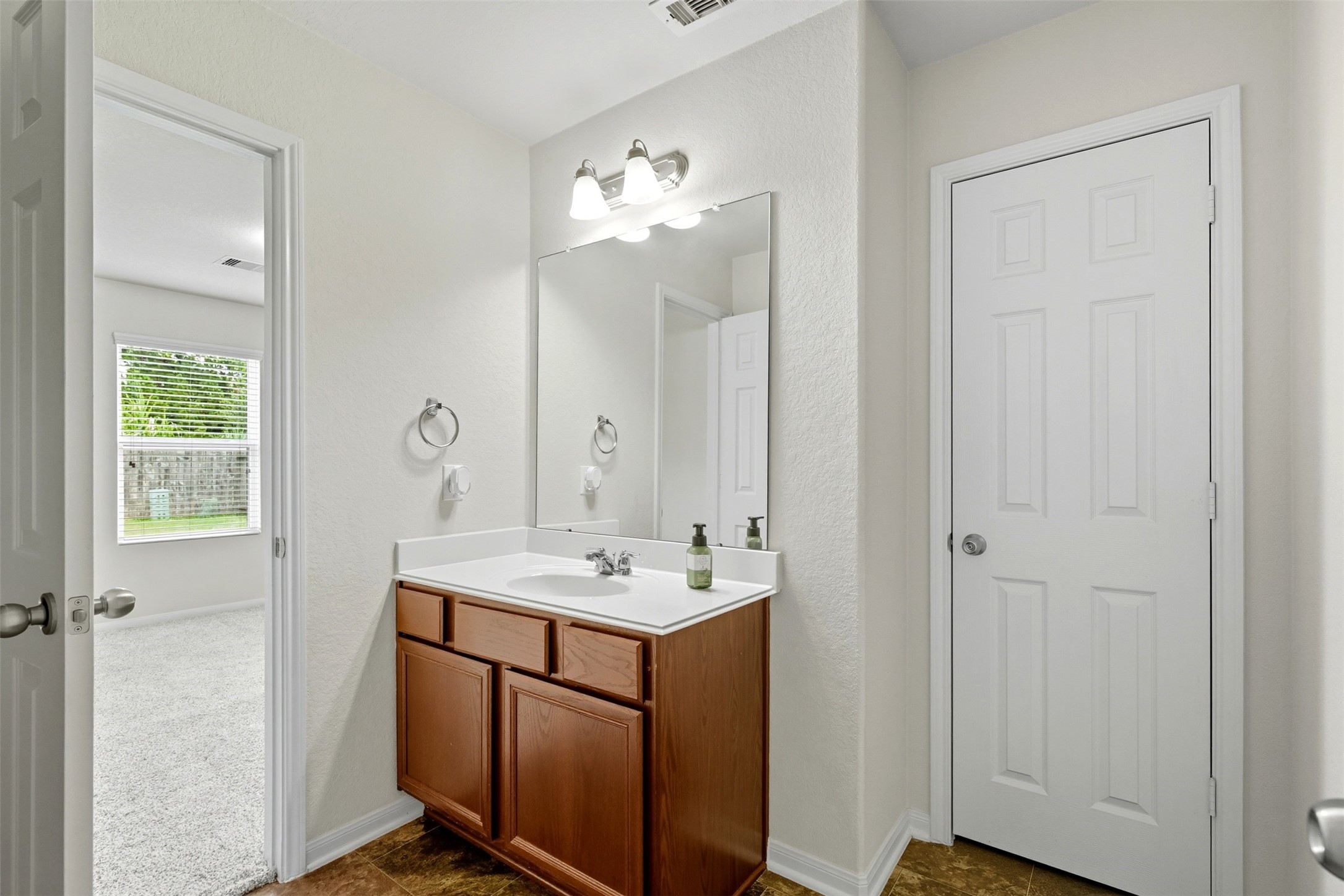 18414 West Hardy Road Houston, TX 77073 - Photo 12 of 46 a bathroom with a sink and a mirror