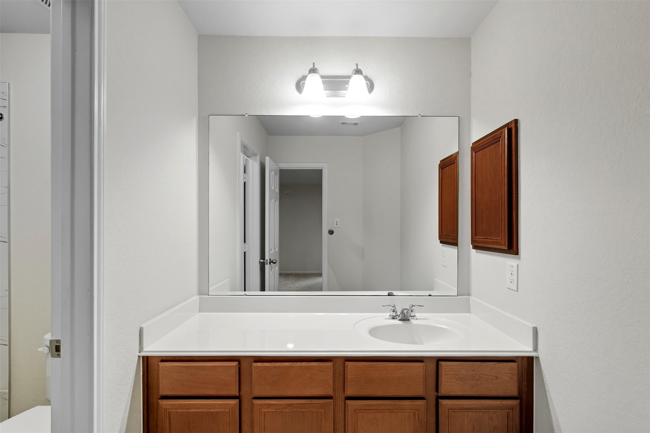 18414 West Hardy Road Houston, TX 77073 - Photo 17 of 46 a bathroom with a sink and a mirror