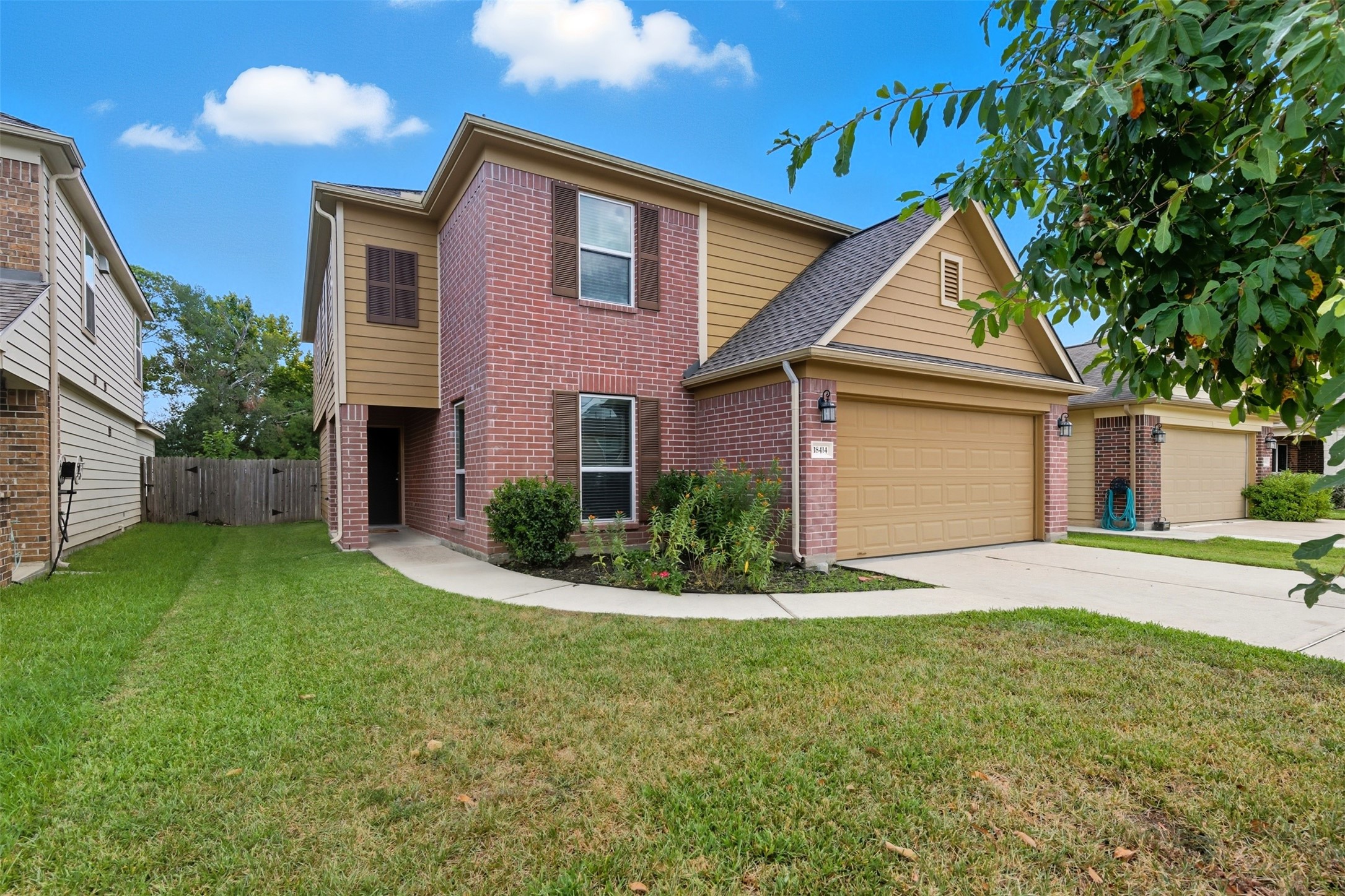 18414 West Hardy Road Houston, TX 77073 - Photo 2 of 46 a front view of a house with a yard and garage