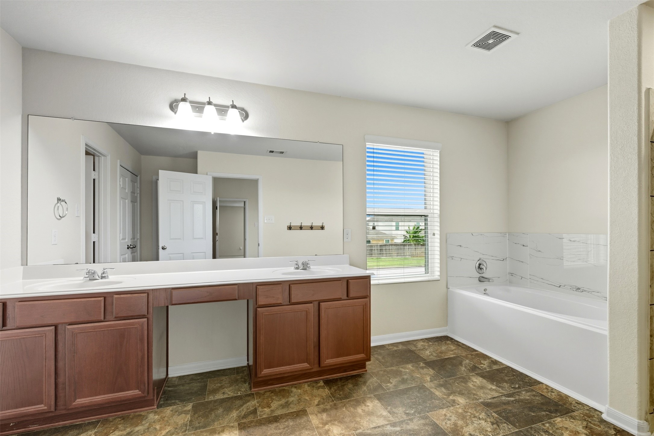18414 West Hardy Road Houston, TX 77073 - Photo 25 of 46 a spacious bathroom with a tub sink and mirror