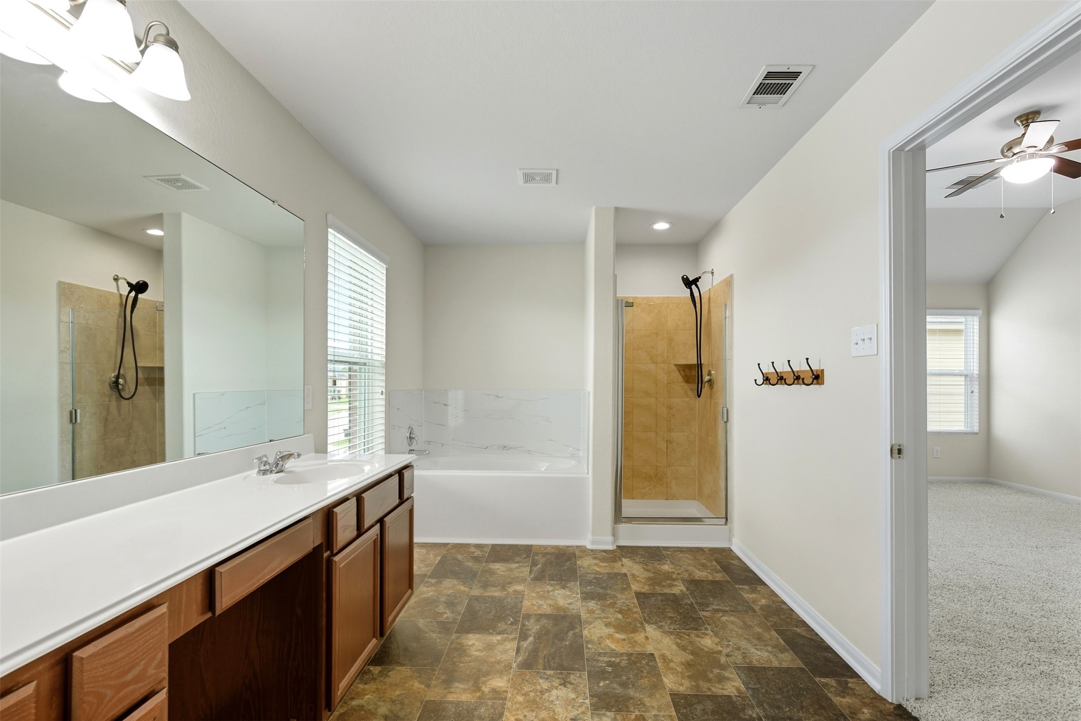 18414 West Hardy Road Houston, TX 77073 - Photo 26 of 46 a bathroom with a shower sink and mirror