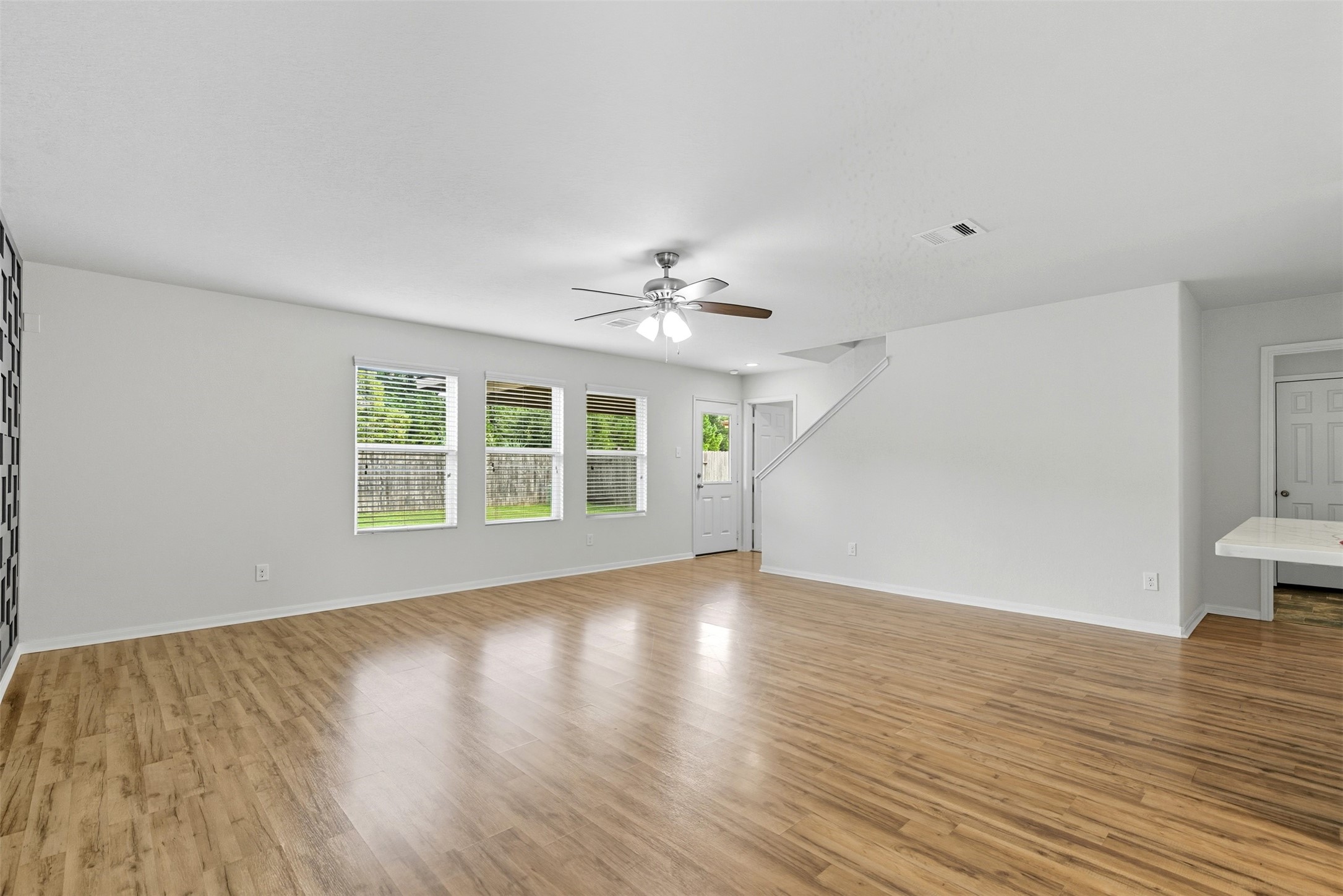 18414 West Hardy Road Houston, TX 77073 - Photo 3 of 46 a view of a livingroom with wooden floor and a ceiling fan