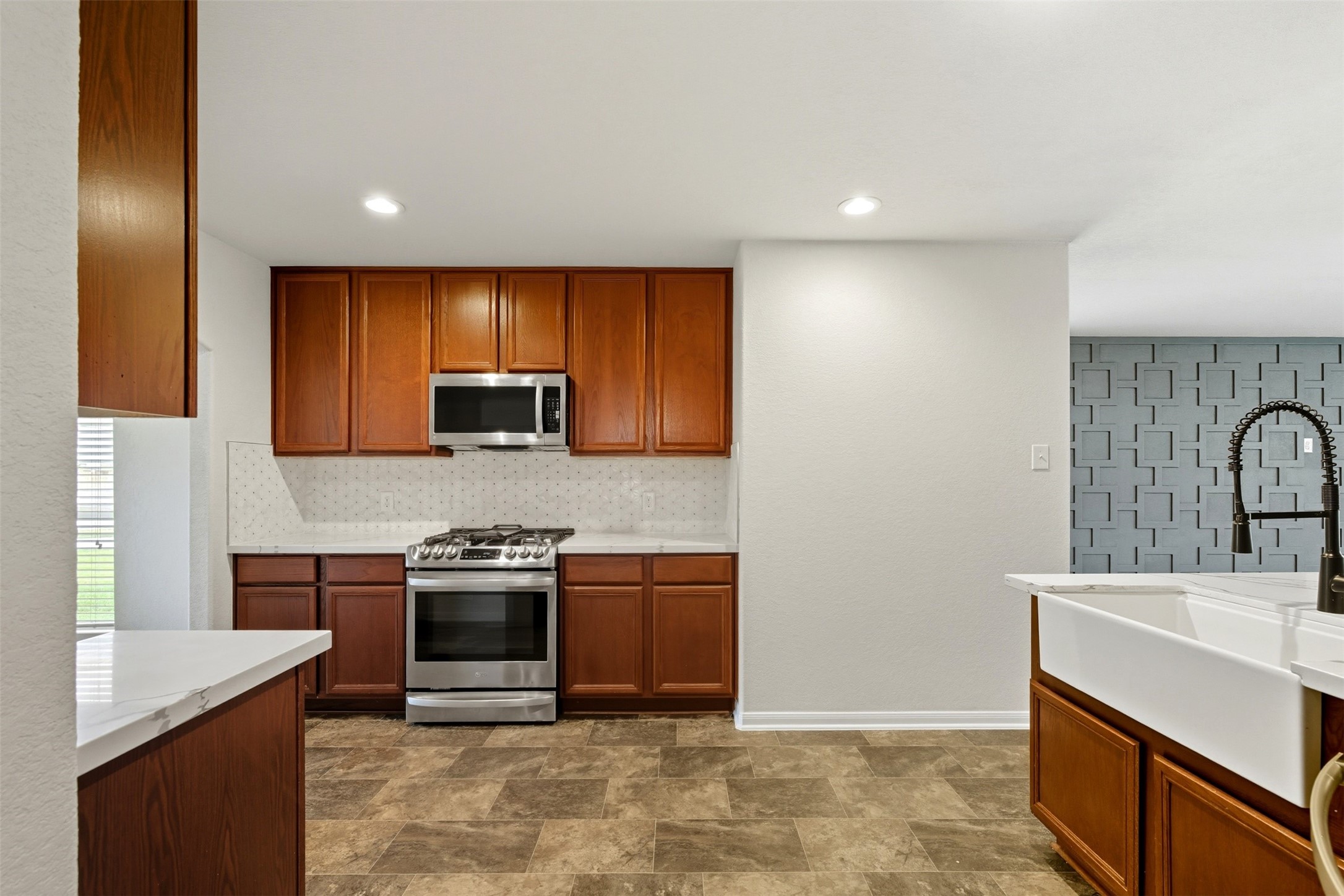 18414 West Hardy Road Houston, TX 77073 - Photo 8 of 46 a kitchen with stainless steel appliances granite countertop a sink stove and refrigerator