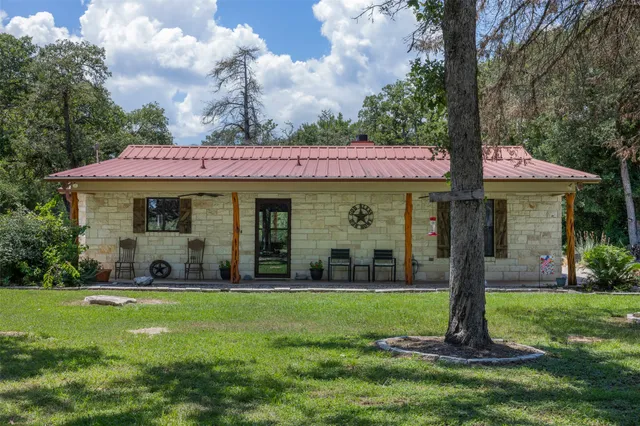 a front view of a house with garden and porch