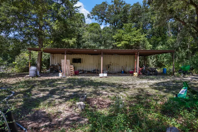 a view of an house with backyard space and balcony