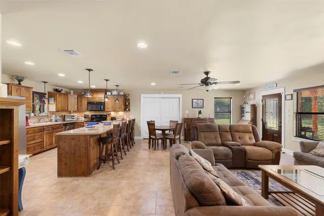 a living room with furniture and kitchen view