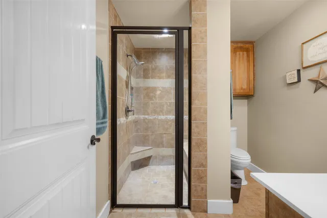 a bathroom with a glass shower door