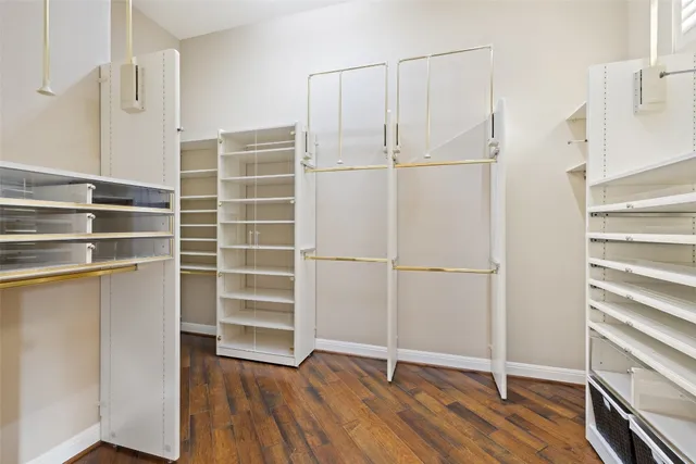 a view of walk in closet with empty racks