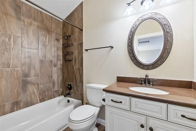 a bathroom with a sink a mirror a toilet and a bathtub