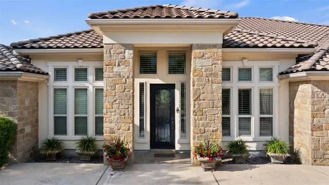 a front view of a house with potted plants