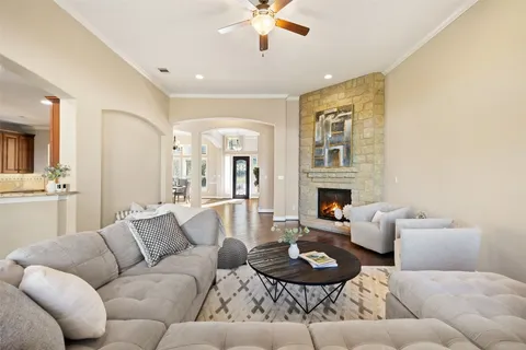 a living room with furniture a fireplace and a wooden floor