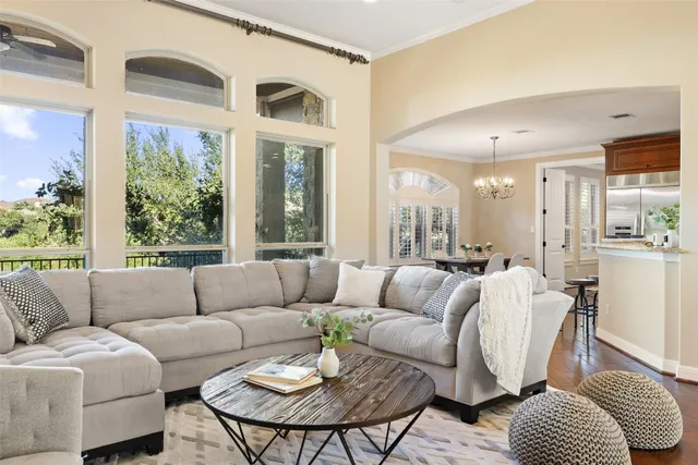 a kitchen with stainless steel appliances granite countertop a stove a sink dishwasher and a refrigerator with wooden floor