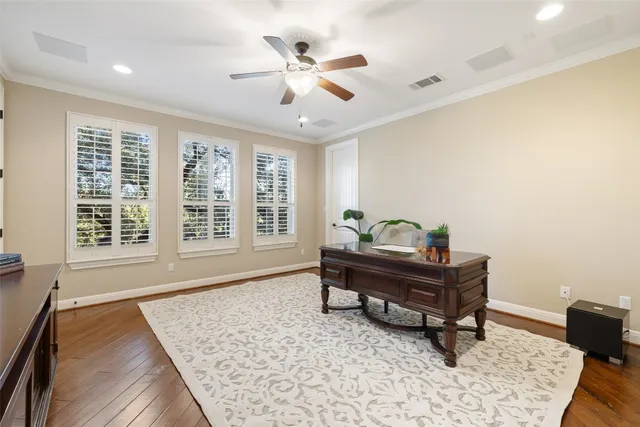 a bedroom with a bed a rug and wooden floor