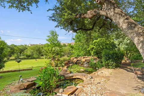a view of backyard with a table and chairs