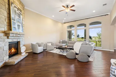 a living room with furniture fireplace and wooden floor